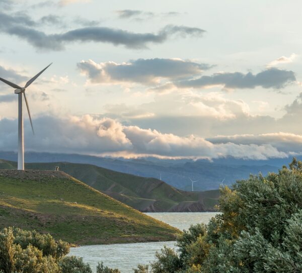 wind-power-turbine-hill-front-cloudy-sky